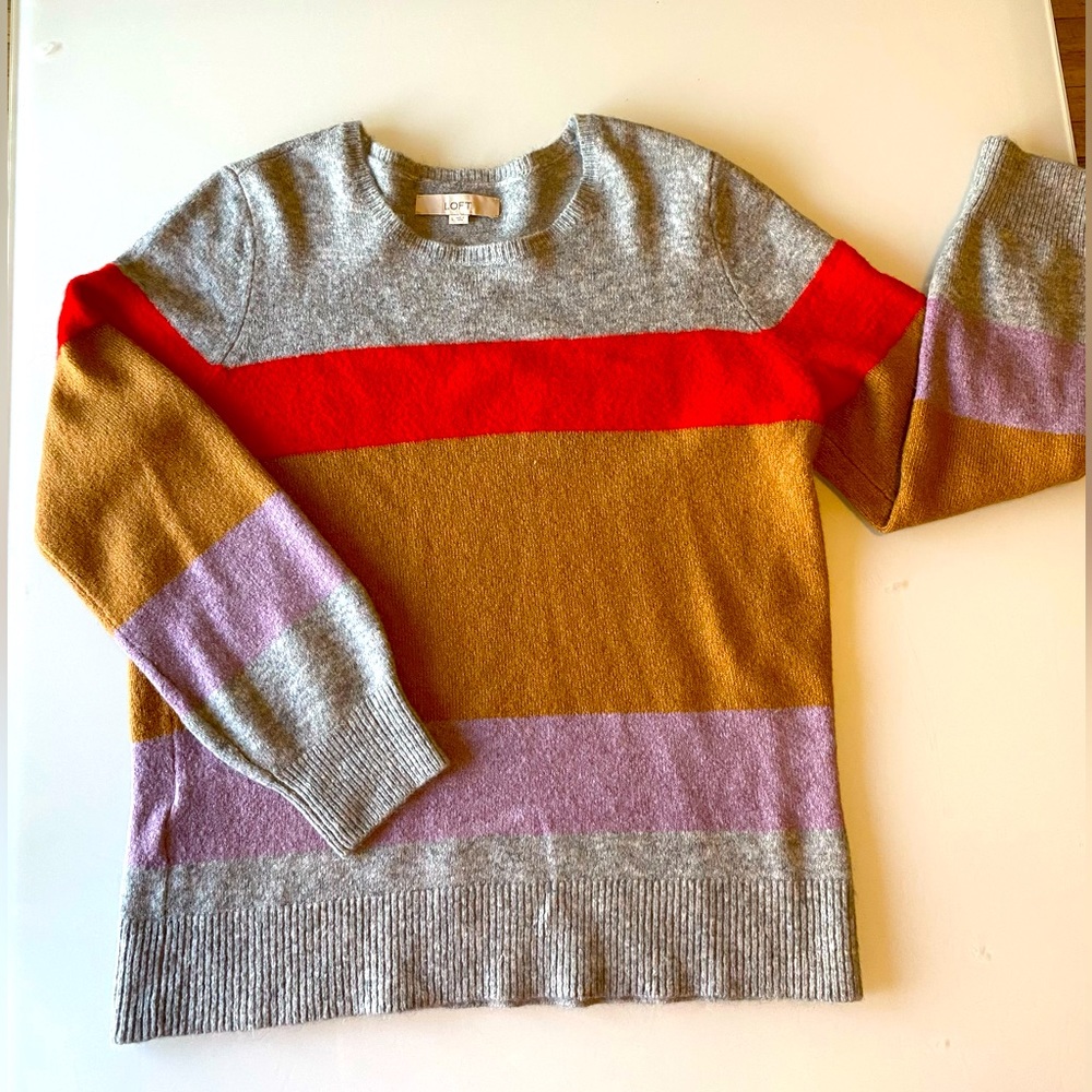 Comfortable sweater. Great color scheme of red, lavender, beige, and grey.